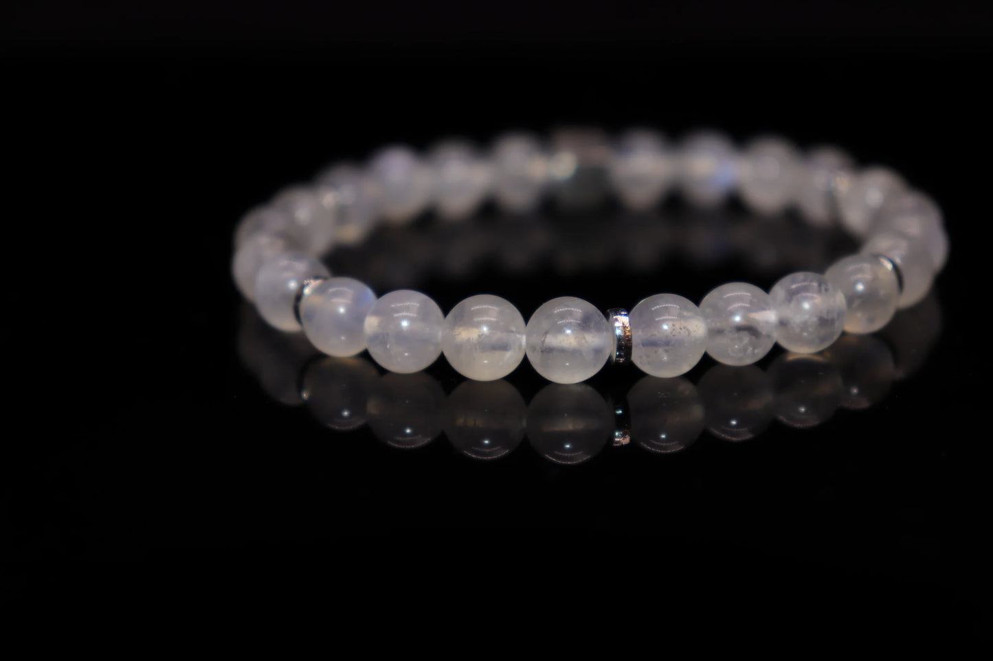 White moonstone silver bracelet worn on wrist, feminine wisdom and flexible strength jewelry, Victorian-era metaphor for women's intelligent power accessory