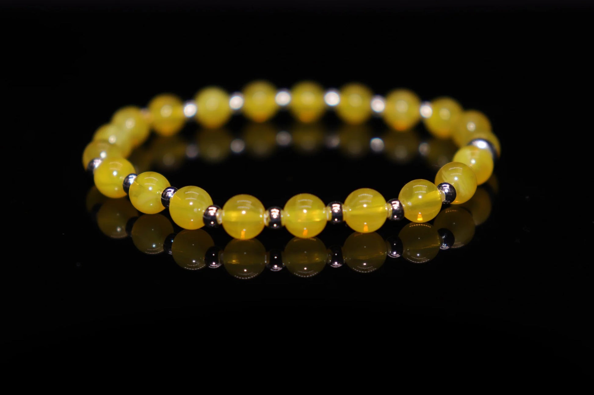 Amber silver bracelet worn on wrist, natural healing energy jewelry with negative ion stress relief, Baltic amber wellness accessory