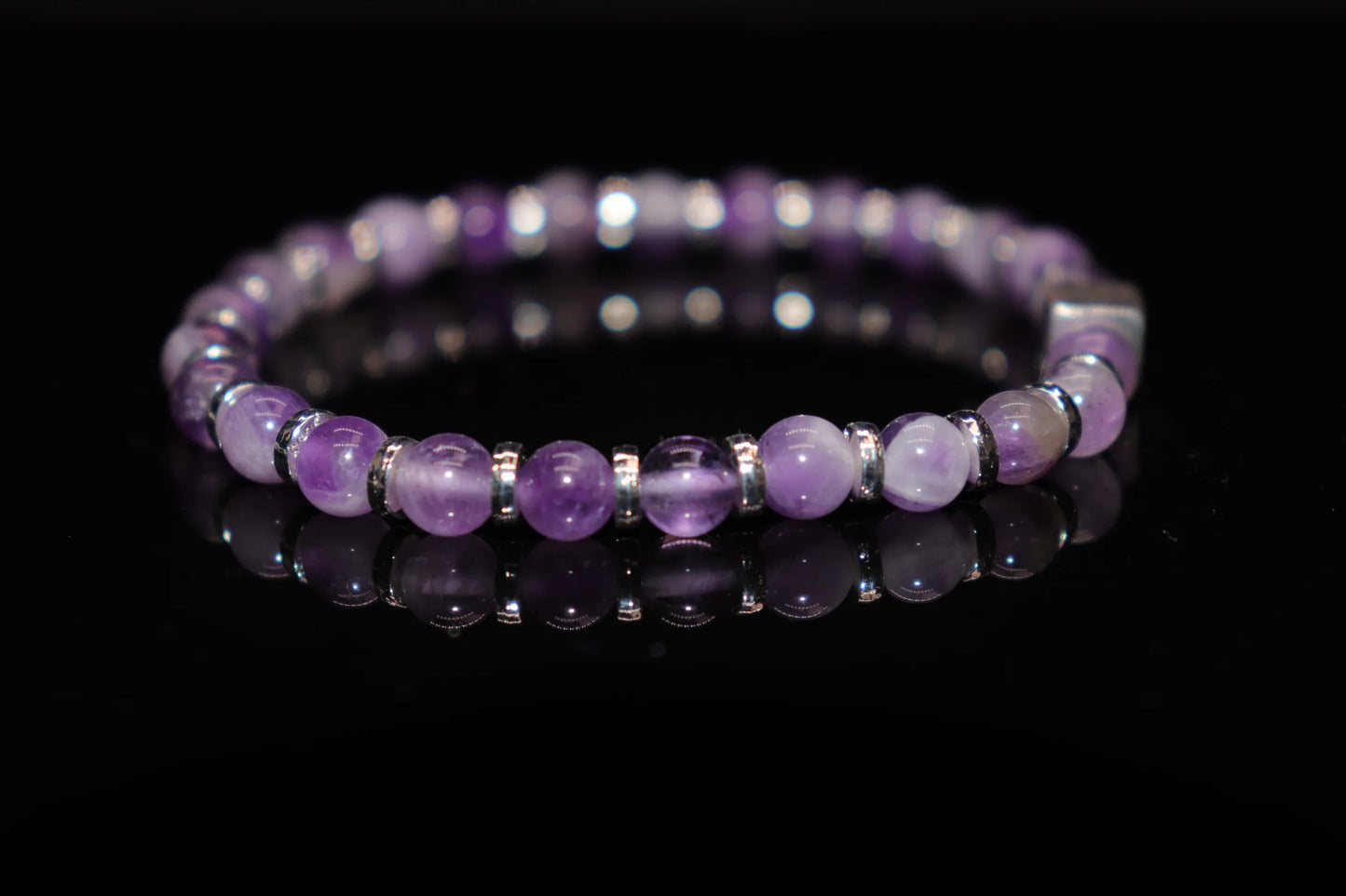 Amethyst silver bracelet worn on wrist, spiritual healing crystal jewelry for crown chakra meditation and inner balance