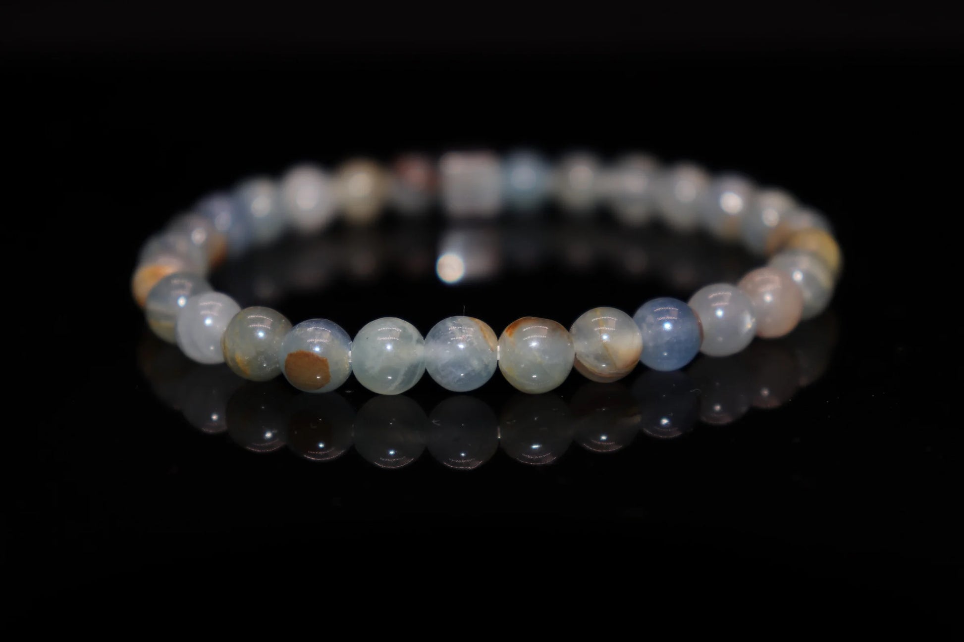 Close-up detail of calcite bracelet showing milky translucent stone texture, medieval alchemical spiritual purification crystal jewelry