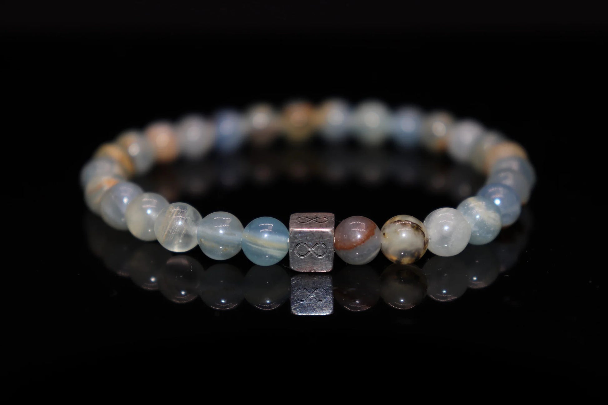 Calcite silver bracelet worn on wrist, grounding healing crystal jewelry for root chakra balance and emotional stability, earth energy accessory