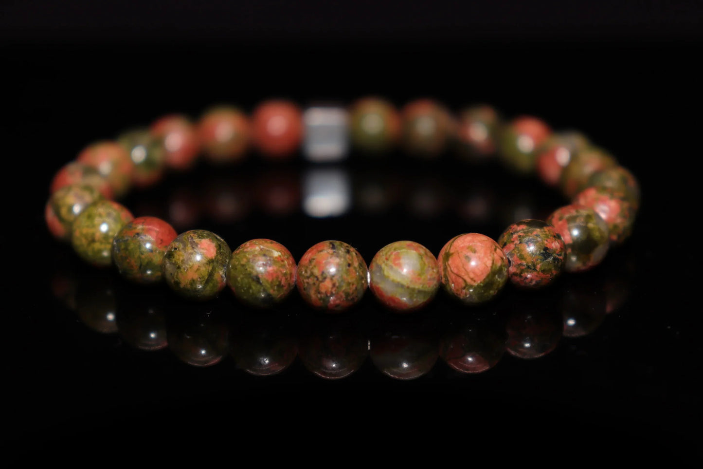 Dragon blood jasper silver bracelet worn on wrist, vitality and inner power crystal jewelry for root chakra energy alignment, healing accessory