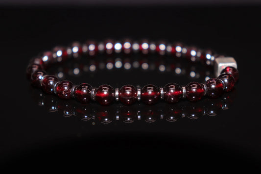Garnet silver bracelet worn on wrist, January birthstone jewelry of protection and eternal love, crusader armor talisman healing accessory