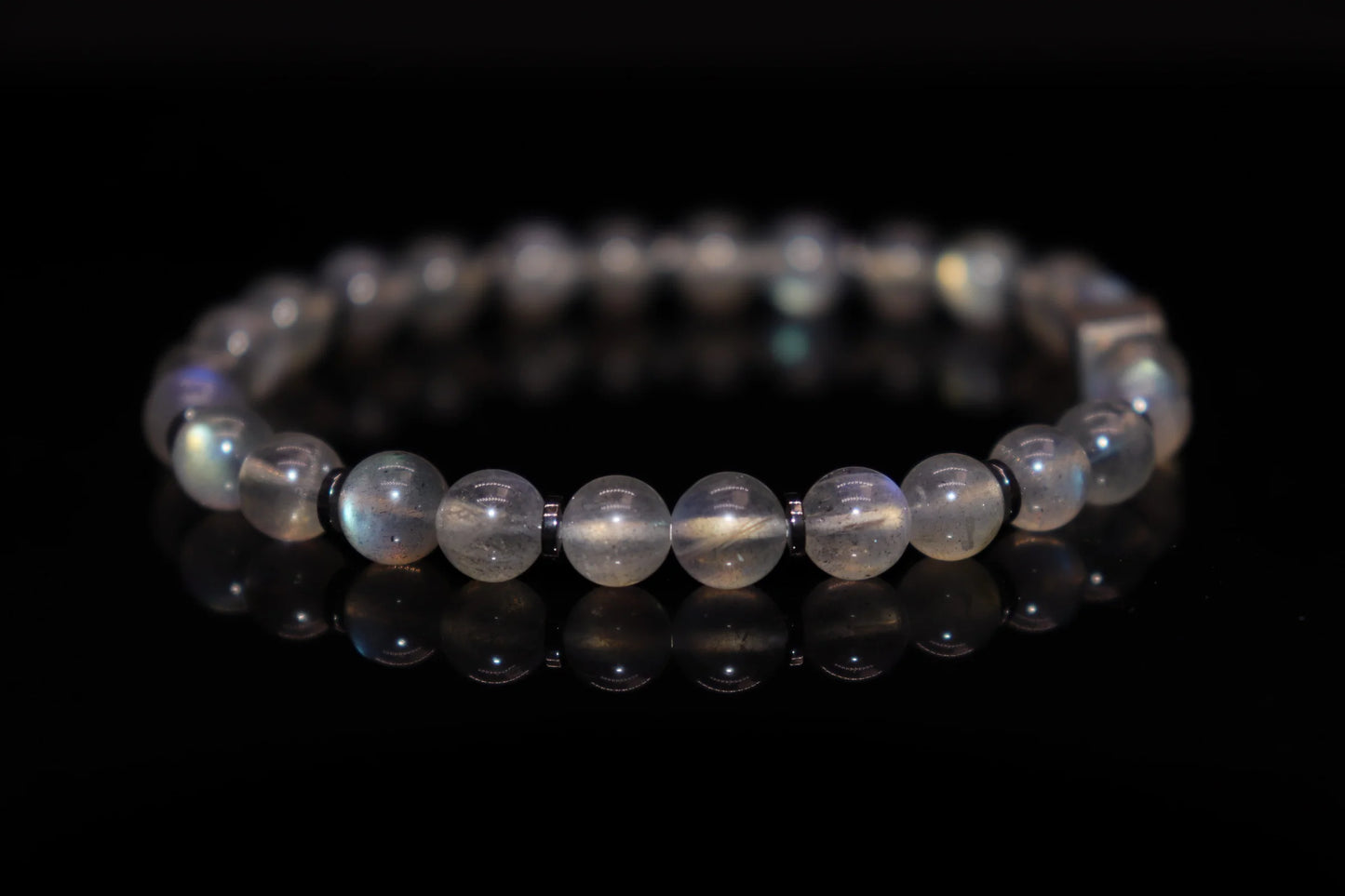 Close-up detail of grey moonstone bracelet showing ethereal silver sheen and adularescence effect, night sky fragment native legend gemstone jewelry