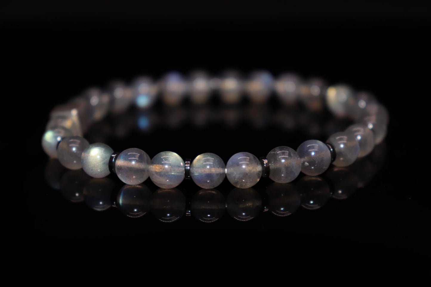 Grey moonstone silver bracelet worn on wrist, intuition-enhancing crystal jewelry for third eye chakra and subconscious mind awakening