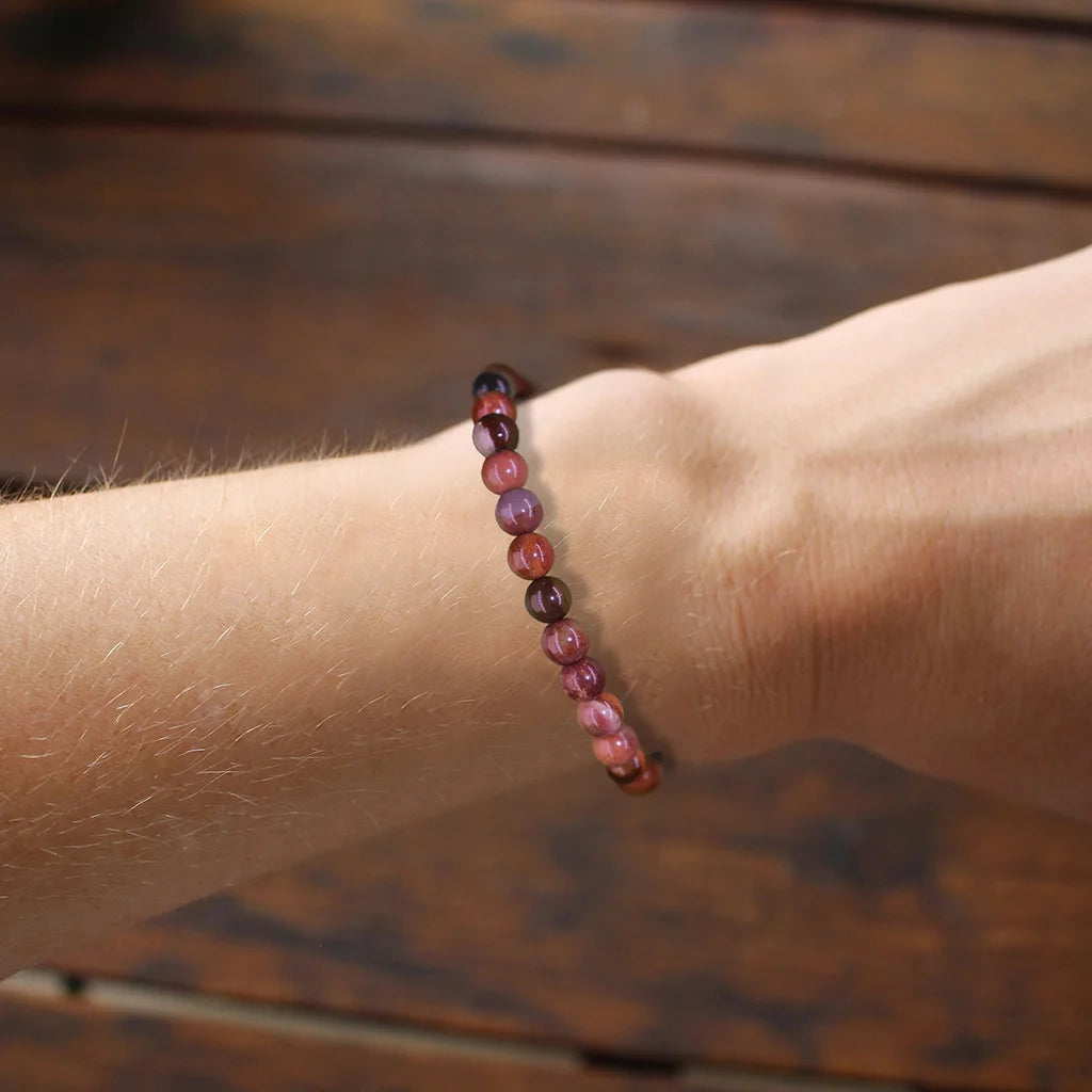 Healing crystal stone bracelet worn on female wrist, natural energy therapy jewelry for emotional relief and spiritual healing, wellness handmade beaded bracelet daily wear