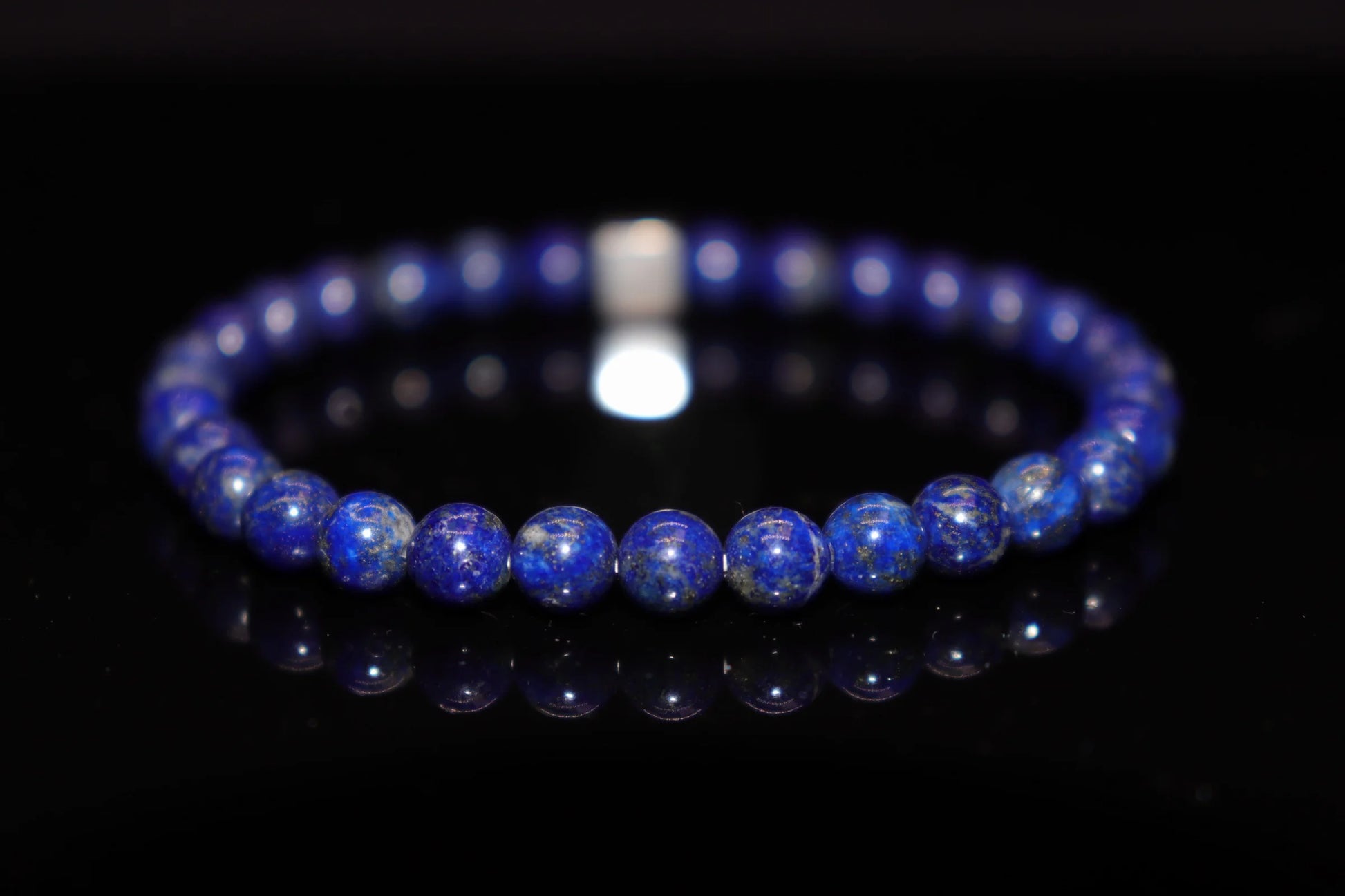 Lapis lazuli silver bracelet worn on wrist, wisdom stone jewelry for throat chakra self-expression and communication, inner truth awakening accessory