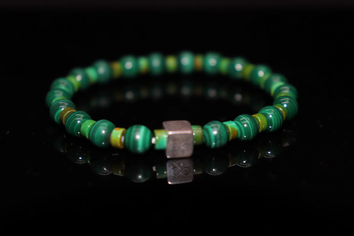 Malachite silver bracelet worn on wrist, healing crystal jewelry for heart chakra balance and negative energy release, emotional wellness accessory