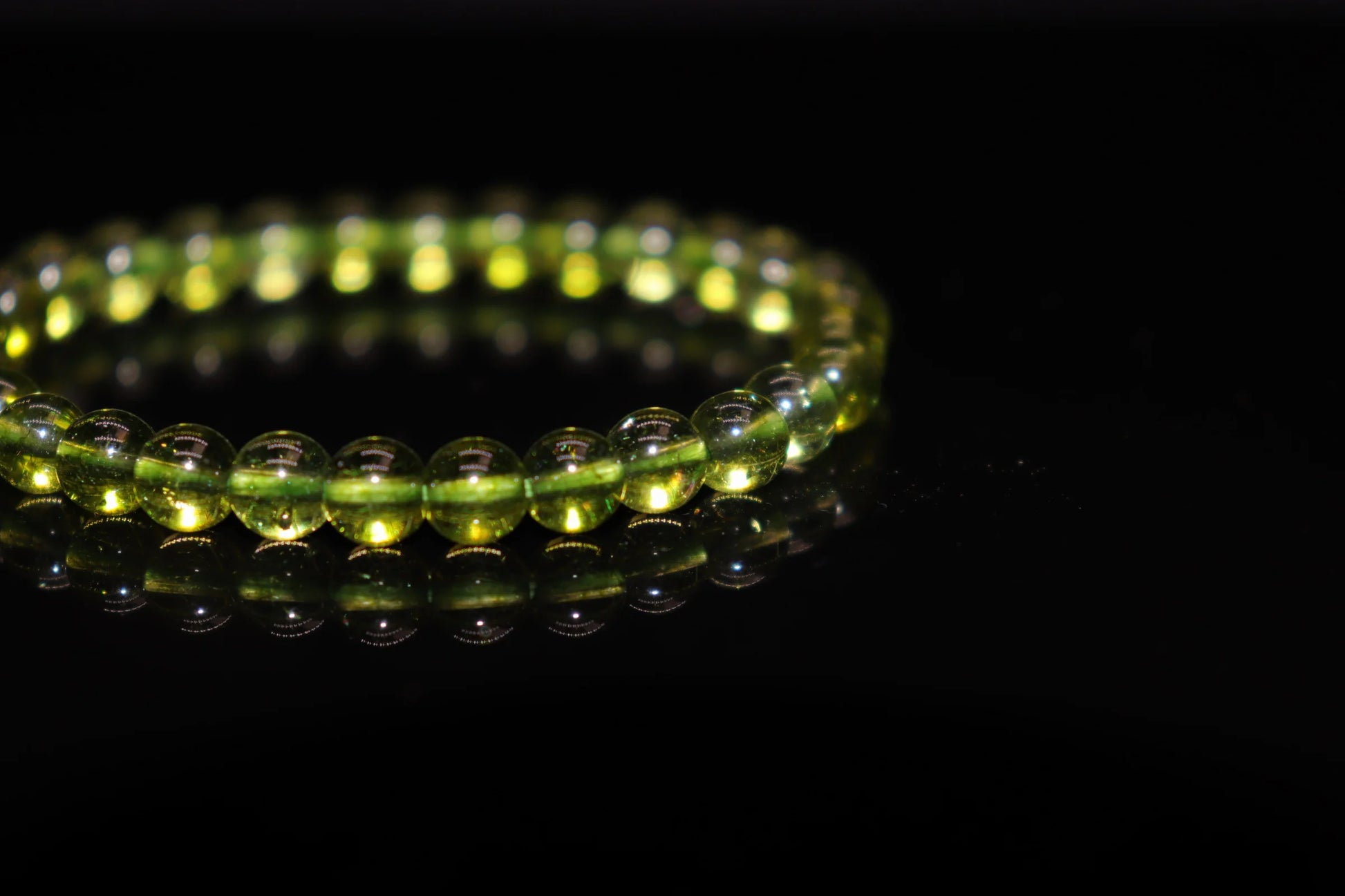 Peridot silver bracelet worn on wrist, August birthstone jewelry of sacred peace and divine protection, ancient Egyptian sun stone healing accessory