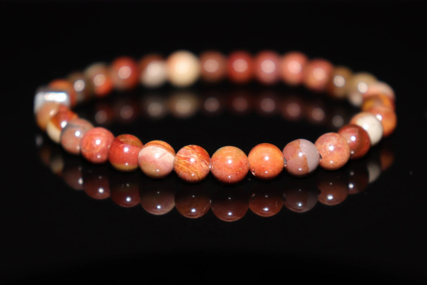 Petrified wood silver bracelet worn on wrist, deep grounding energy jewelry connecting to earth wisdom, ancestral stone healing accessory