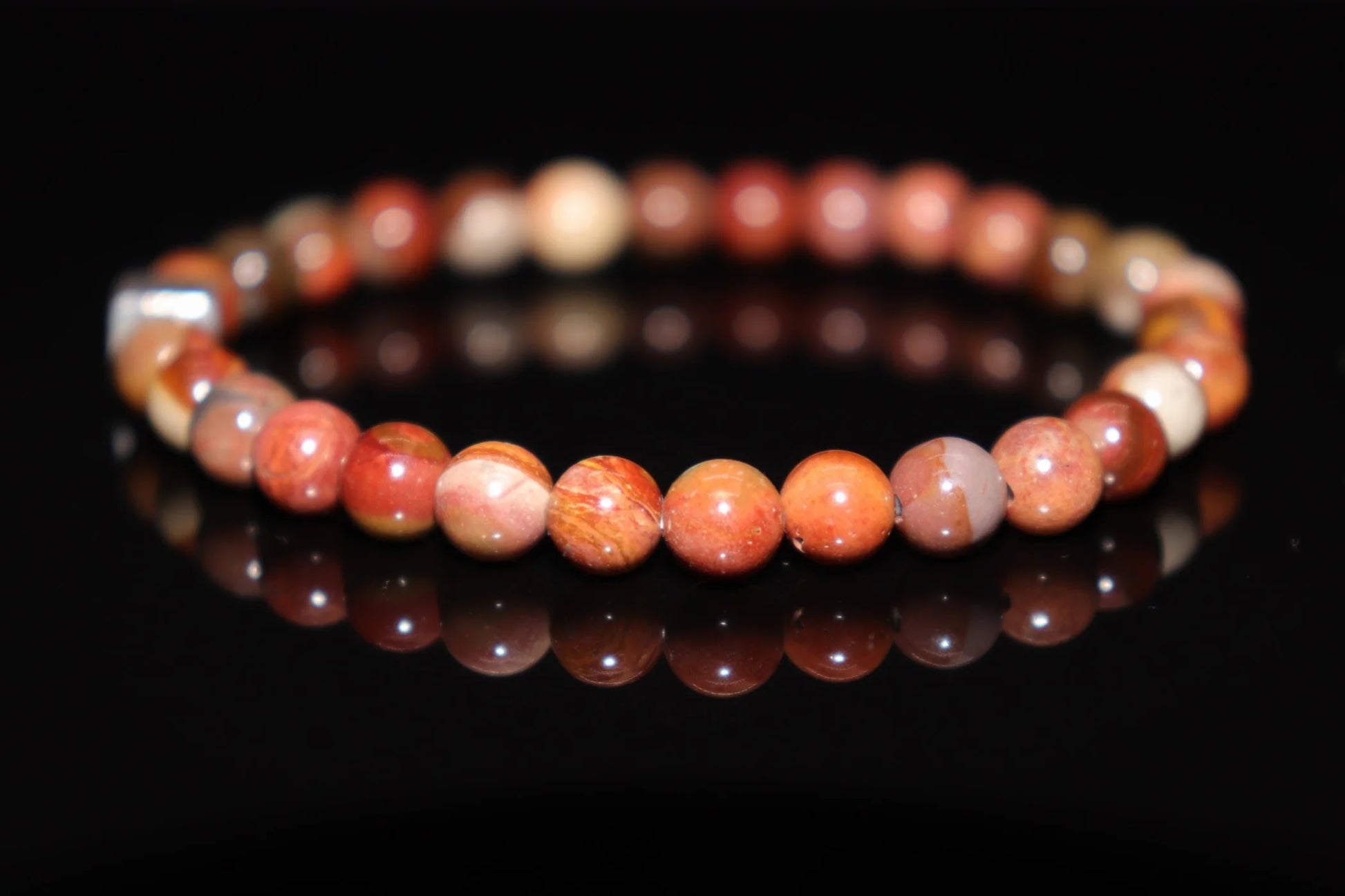 Petrified wood silver bracelet worn on wrist, deep grounding energy jewelry connecting to earth wisdom, ancestral stone healing accessory