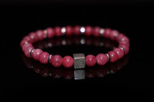 Close-up detail of rhodochrosite bracelet showing distinctive pink and white banding texture, Zeus and Io Greek love redemption myth gemstone jewelry