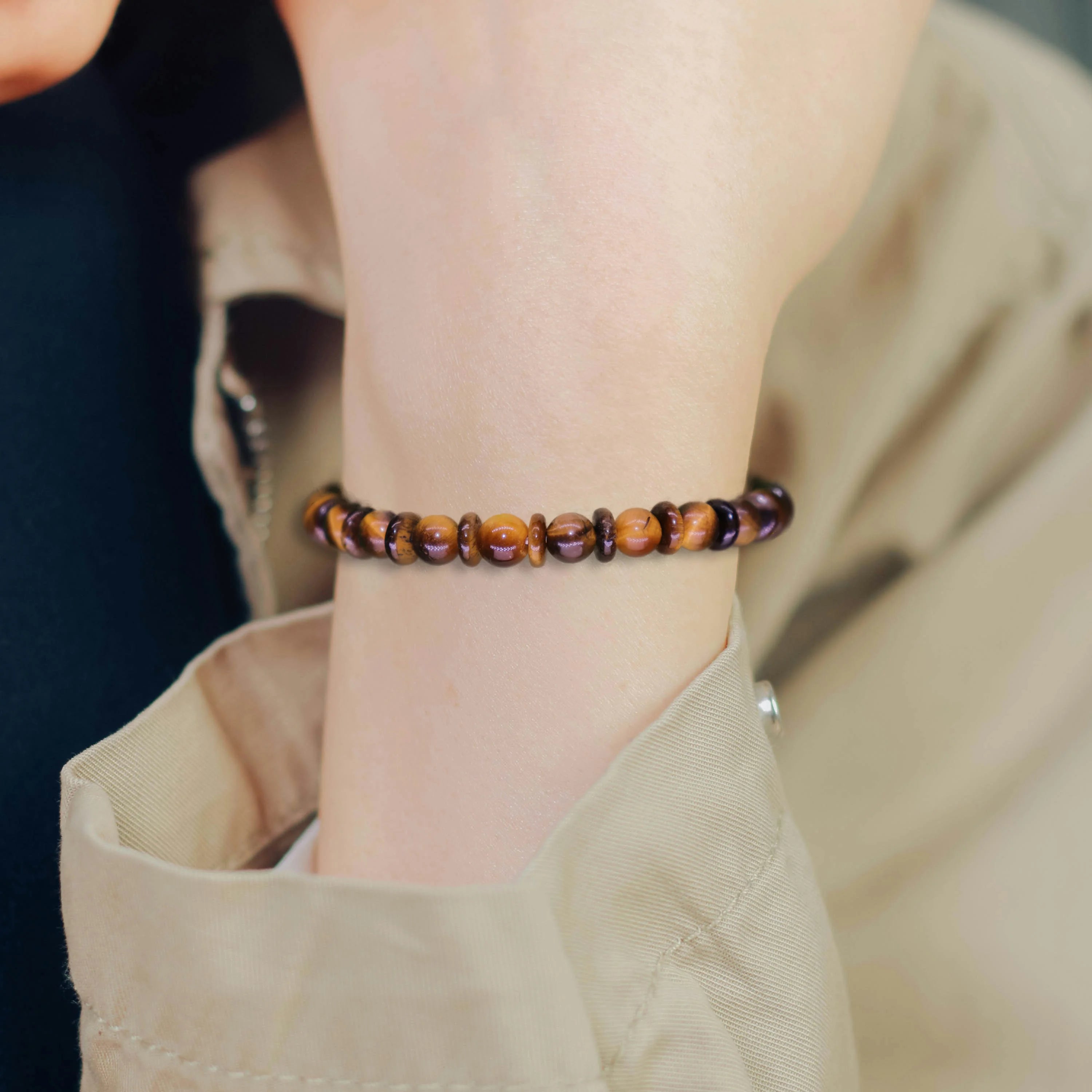 Tiger eye bracelet worn daily on wrist close-up, natural golden brown chatoyancy crystal jewelry for everyday courage and protection, casual style accessory photo
