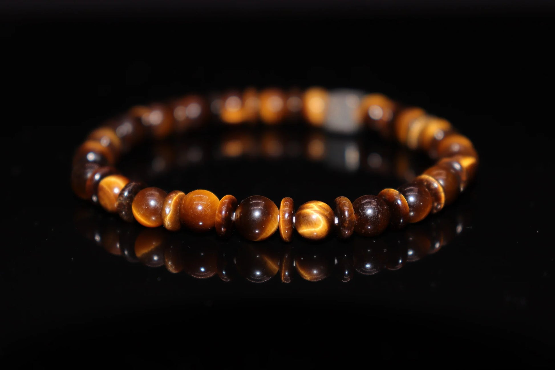 Close-up detail of tiger eye bracelet showing silky luster and moving light band effect, ancient Egyptian Eye of Ra sun god temple stone jewelry
