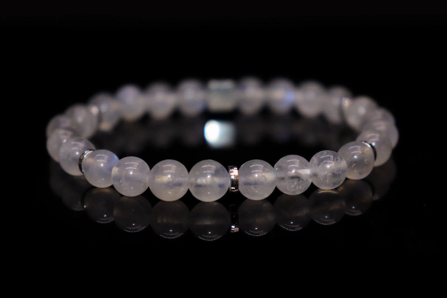 Close-up detail of white moonstone bracelet showing mesmerizing blue-white sheen and adularescence effect, Diana Selene sacred gemstone jewelry