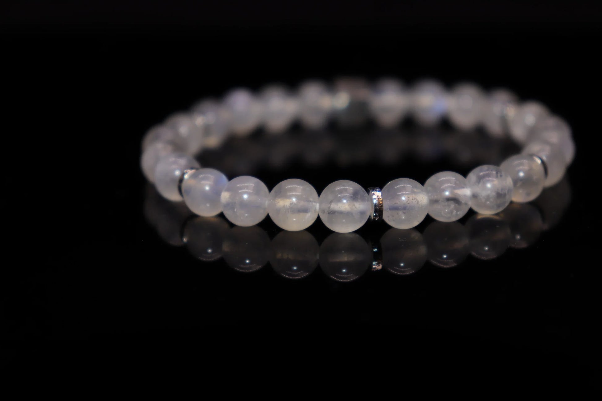 White moonstone silver bracelet worn on wrist, feminine wisdom and flexible strength jewelry, Victorian-era metaphor for women's intelligent power accessory